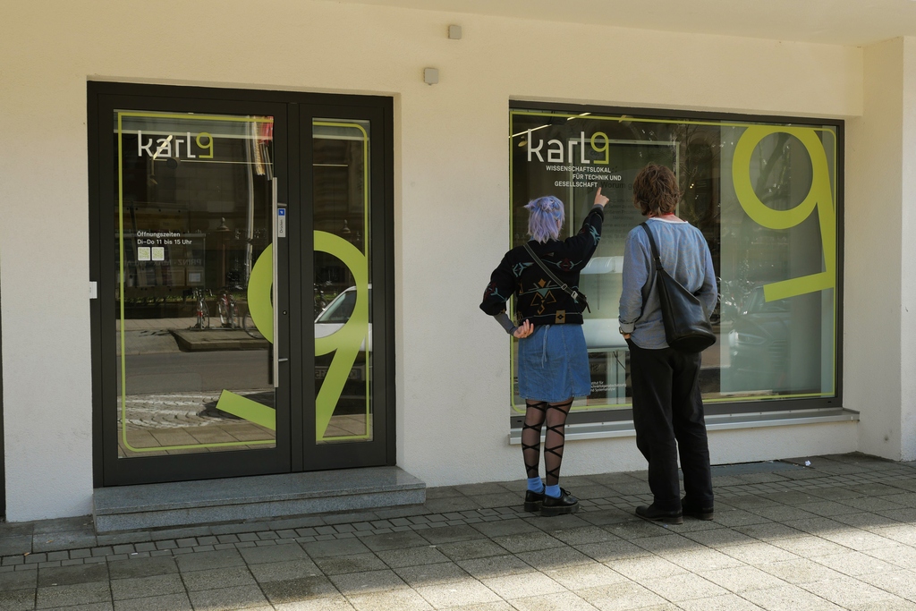 2 Menschen vor dem Karl9-Schaufenster